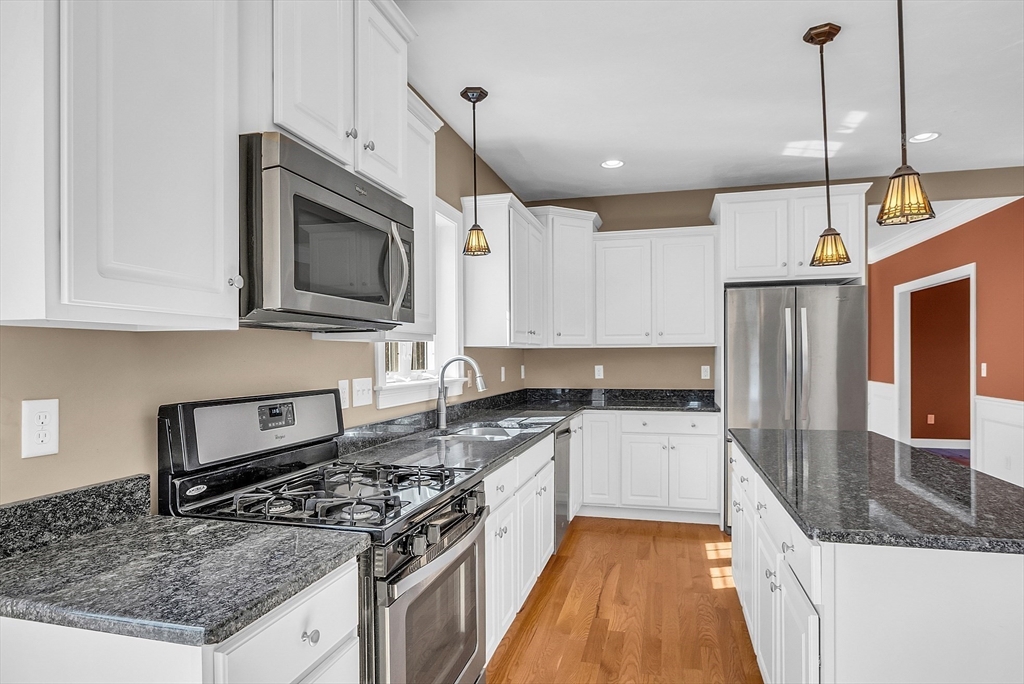 17 Runaway Brook Road Lancaster, MA 01523 - Photo 18 of 42 a kitchen with stainless steel appliances granite countertop a stove a sink and a microwave