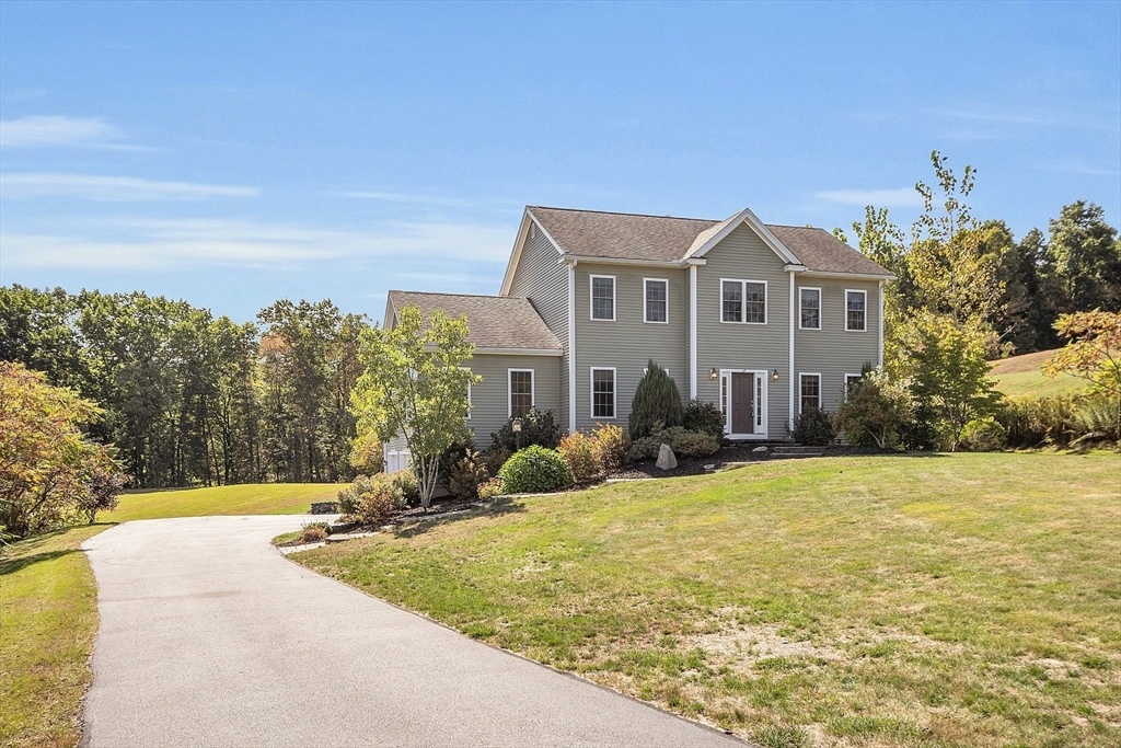 17 Runaway Brook Road Lancaster, MA 01523 - Photo 2 of 42 a front view of a house with yard and trees