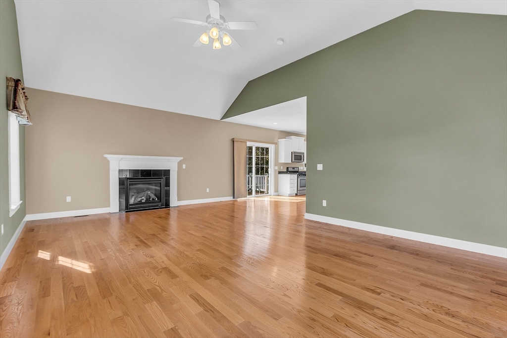 17 Runaway Brook Road Lancaster, MA 01523 - Photo 21 of 42 a view of empty room with wooden floor and fireplace