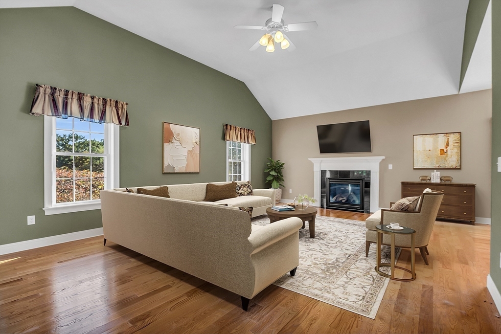 17 Runaway Brook Road Lancaster, MA 01523 - Photo 23 of 42 a living room with furniture a fireplace and a flat screen tv