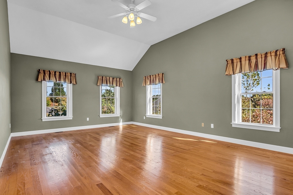 17 Runaway Brook Road Lancaster, MA 01523 - Photo 24 of 42 a view of an empty room with a window and wooden floor