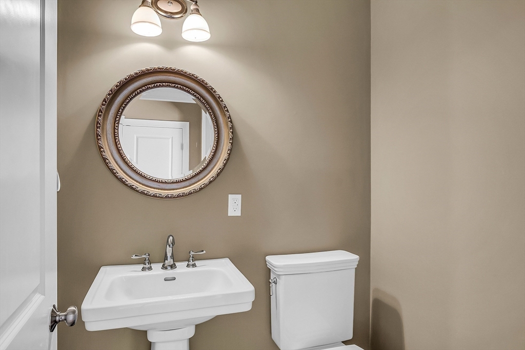 17 Runaway Brook Road Lancaster, MA 01523 - Photo 25 of 42 a bathroom with a sink a mirror and a toilet