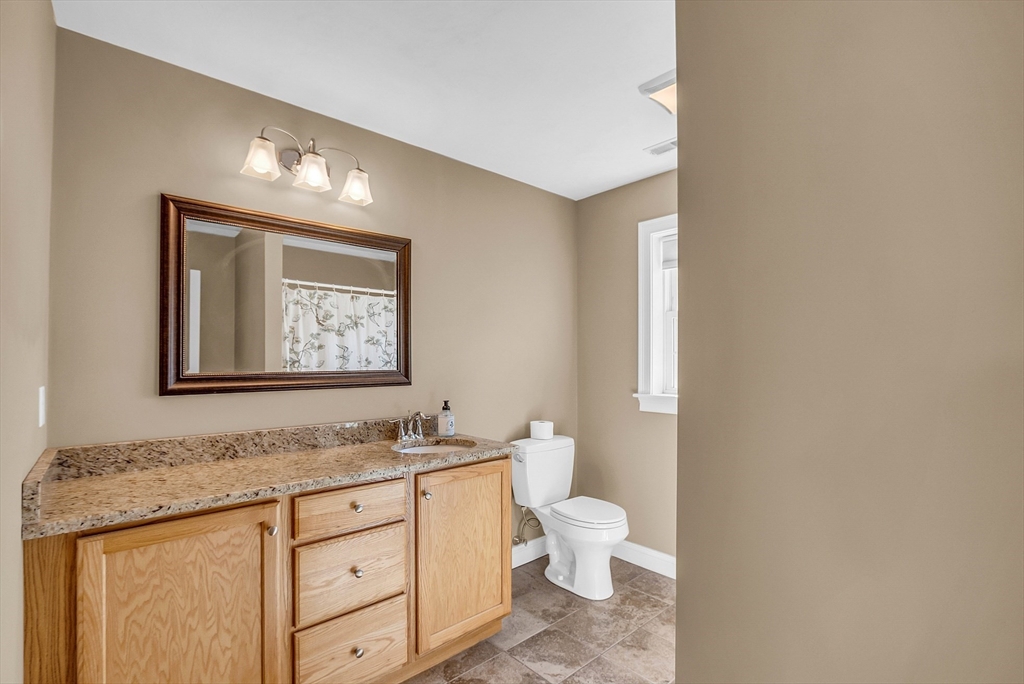 17 Runaway Brook Road Lancaster, MA 01523 - Photo 28 of 42 a bathroom with a granite countertop toilet sink and mirror