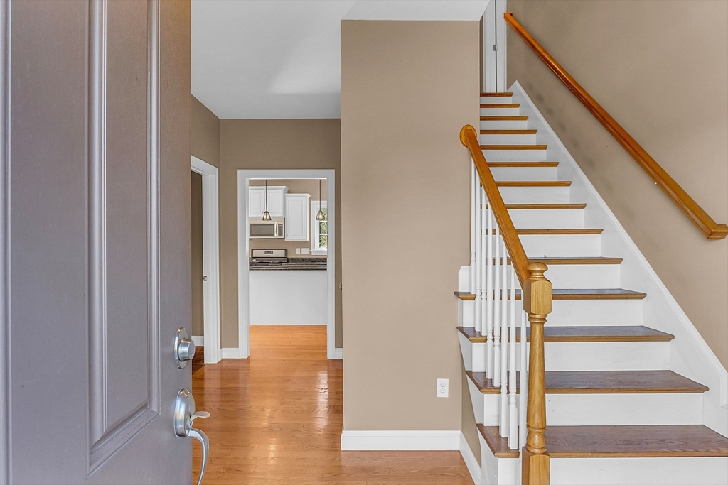 17 Runaway Brook Road Lancaster, MA 01523 - Photo 3 of 42 a view of a hallway with wooden floor and staircase