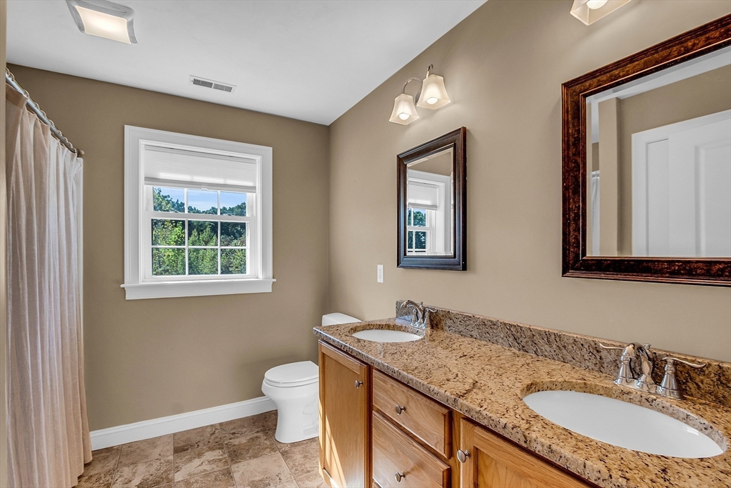 17 Runaway Brook Road Lancaster, MA 01523 - Photo 31 of 42 a bathroom with a granite countertop sink toilet and mirror