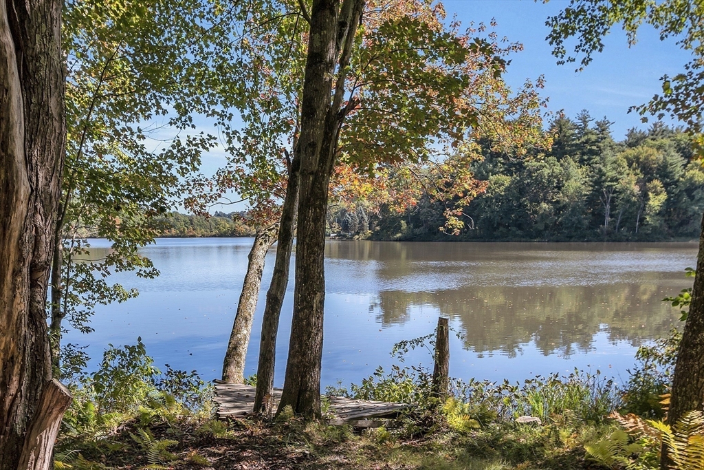 17 Runaway Brook Road Lancaster, MA 01523 - Photo 39 of 42 a view of a lake with a tree in the background