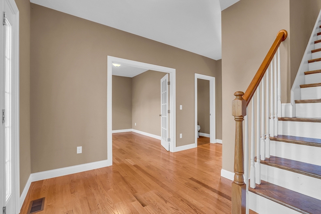 17 Runaway Brook Road Lancaster, MA 01523 - Photo 4 of 42 a view of a hallway with wooden floor and staircase