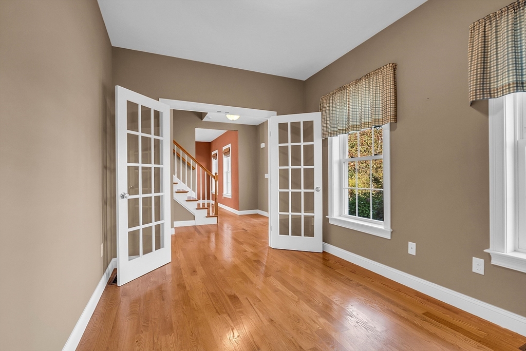17 Runaway Brook Road Lancaster, MA 01523 - Photo 7 of 42 an empty room with wooden floor and windows