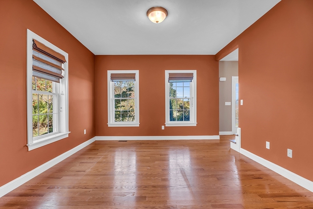 17 Runaway Brook Road Lancaster, MA 01523 - Photo 8 of 42 a view of an empty room with wooden floor and a window
