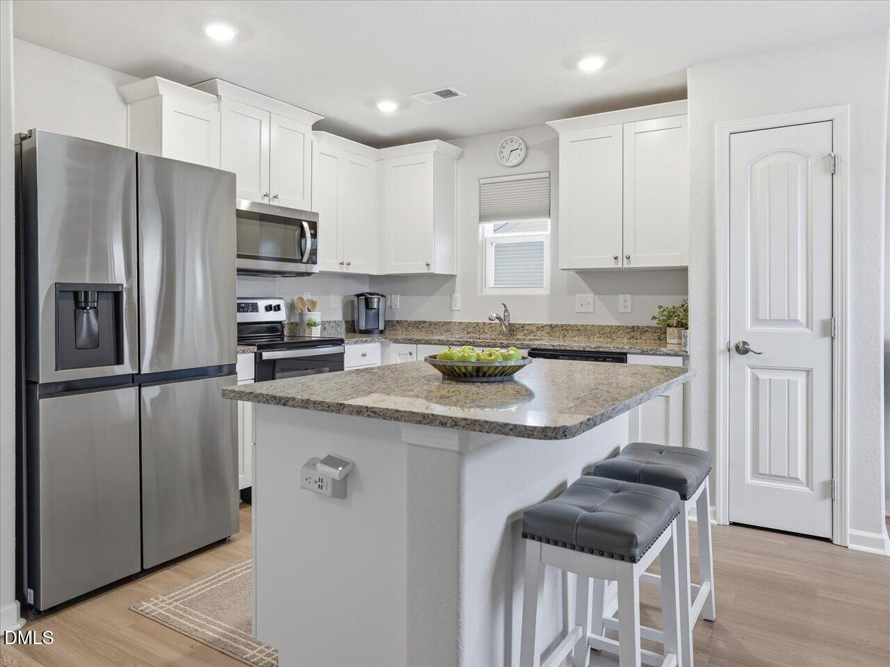 90 Barnsley Road Angier, NC 27501 - Photo 13 of 40 a kitchen with stainless steel appliances granite countertop a refrigerator a sink a stove a microwave and island