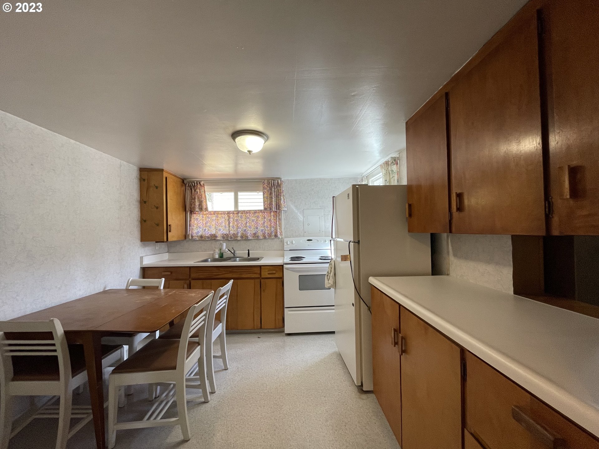 430 E Street Springfield, OR 97477 - Photo 13 of 29 a kitchen with a table and chairs in it