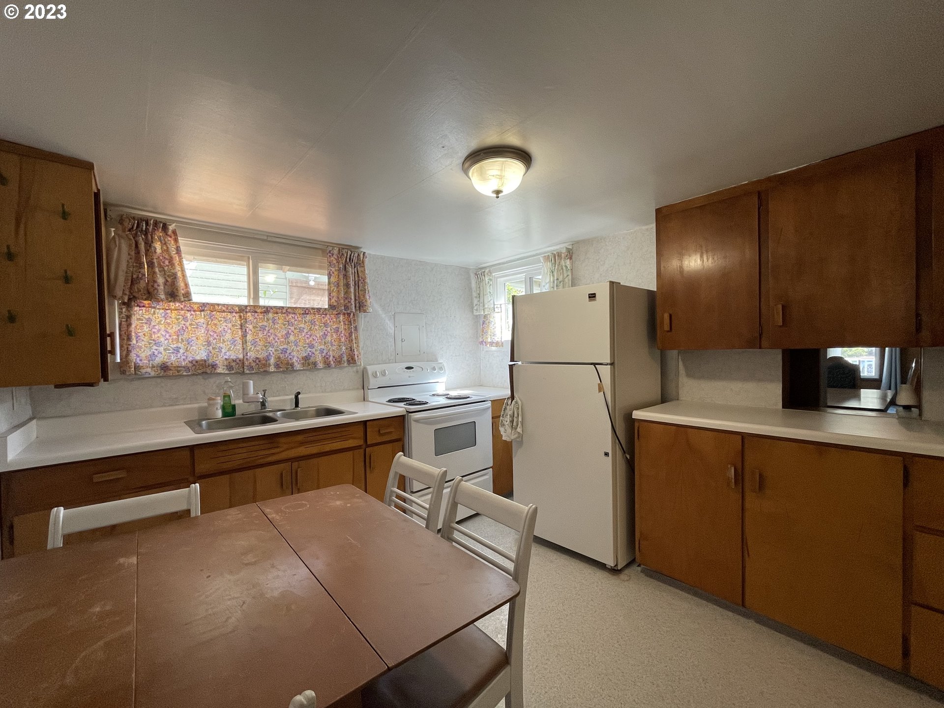 430 E Street Springfield, OR 97477 - Photo 14 of 29 a kitchen with refrigerator a sink and cabinets