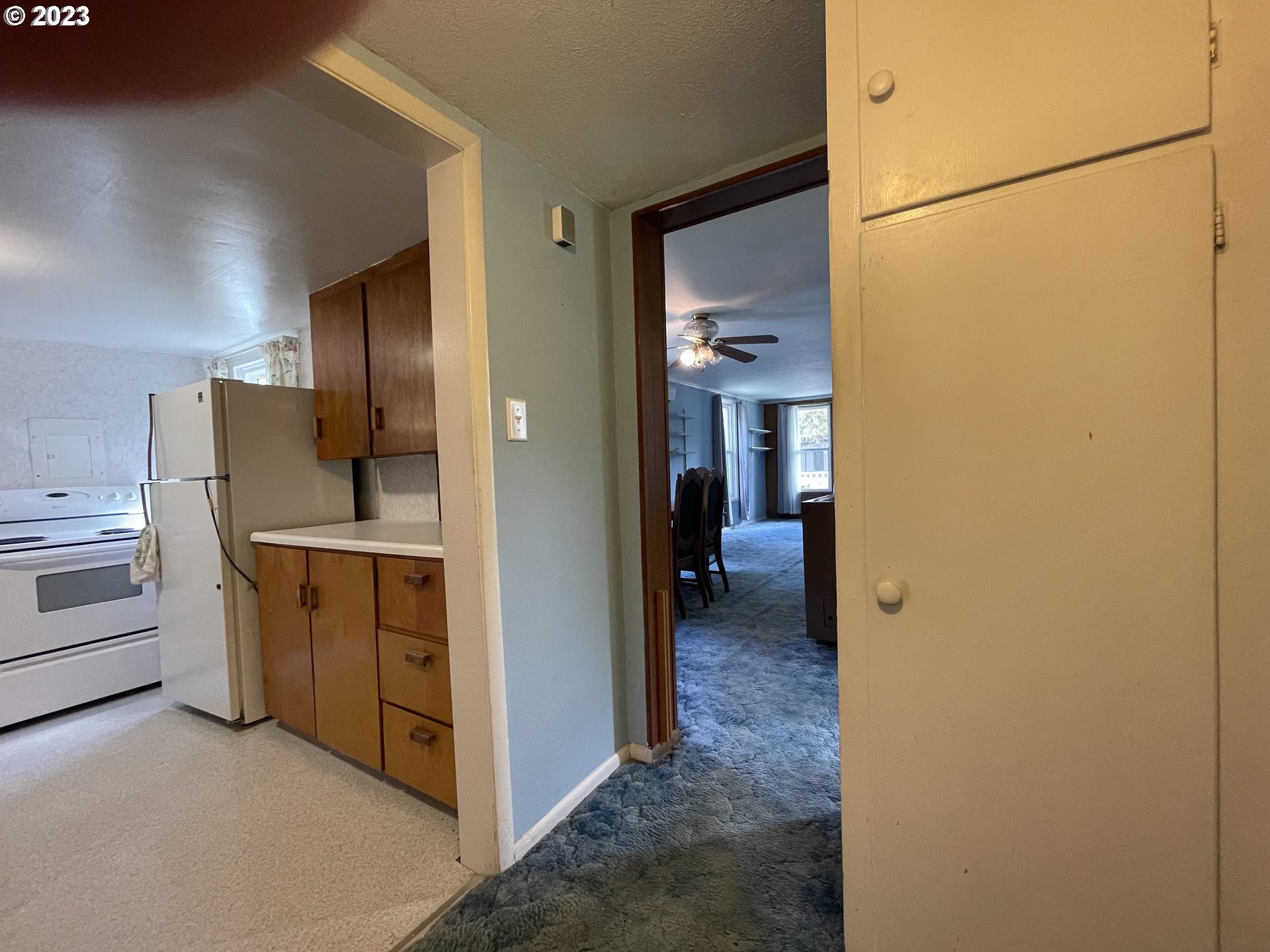 430 E Street Springfield, OR 97477 - Photo 20 of 29 a view of a hallway with kitchen space and refrigerator