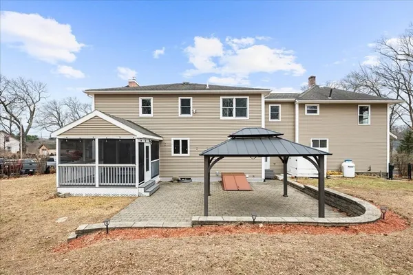 a backyard of a house with yard fire pit and outdoor seating