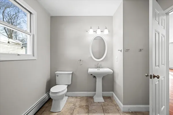 a view of bathroom with a toilet sink and mirror