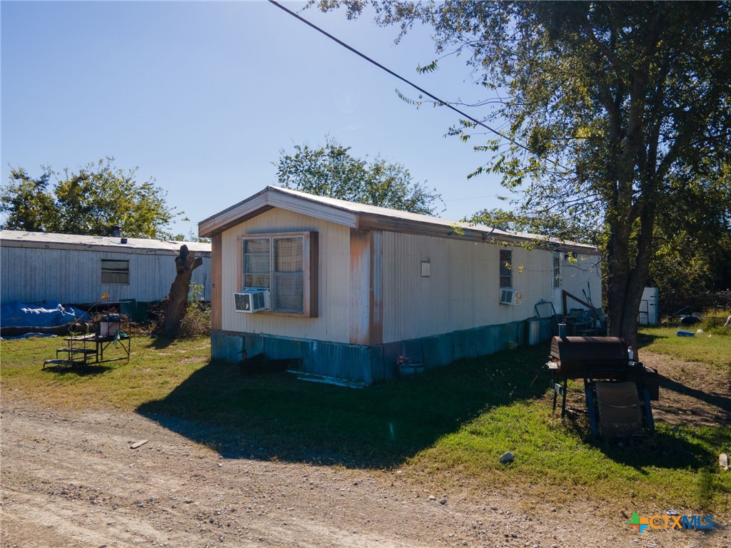 4592 County Road 3220 Kempner, TX 76539 - Photo 5 of 12 a backyard of a house with wooden fence and a tree