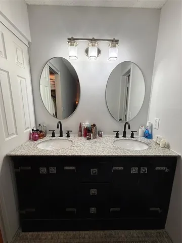 a bathroom with a double vanity sink and a mirror