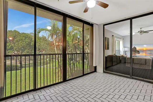 a bedroom with a balcony and large window