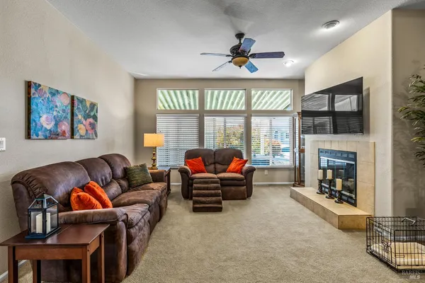 a living room with furniture and a fireplace