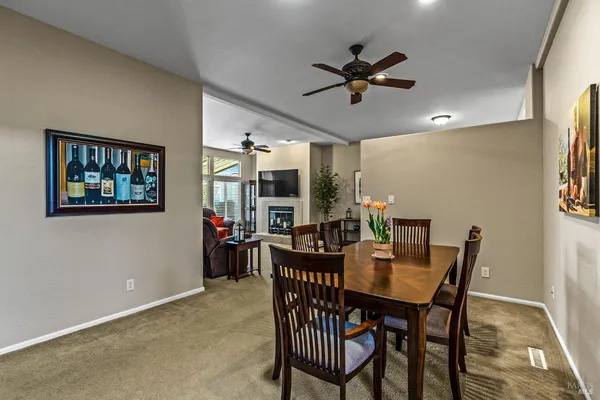 a view of a dining room with furniture and chandelier