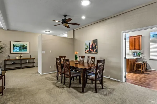 a kitchen with stainless steel appliances granite countertop a stove top oven a sink dishwasher and a refrigerator with the cabinets