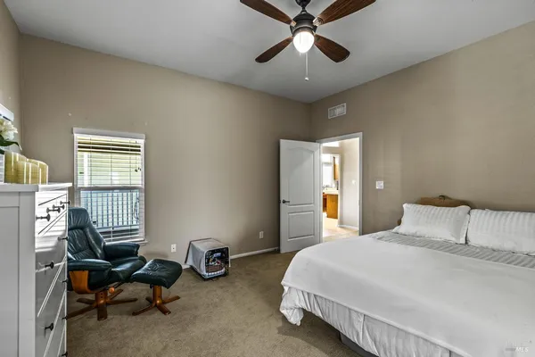 a bedroom with a bed a couch and a window