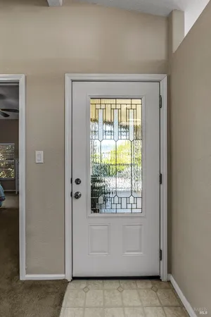 a view of a hallway to rooms and stairs