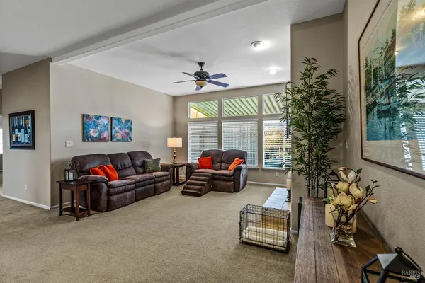 a living room with furniture a fireplace and a large window