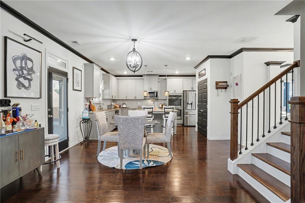 110 Canal Street Hampton, GA 30228 - Photo 14 of 41 a living room with lots of wooden furniture and kitchen view