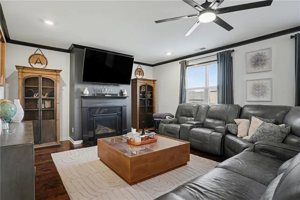 a living room with fireplace furniture and a flat screen tv