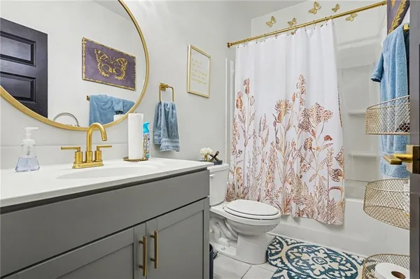 a bathroom with a sink a toilet and shower curtain