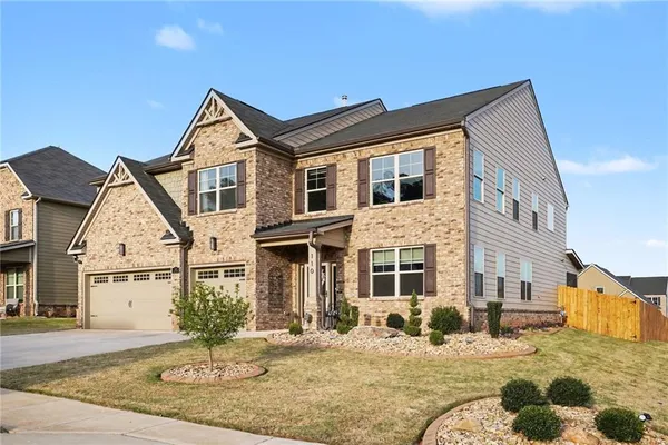 a front view of a house with a yard