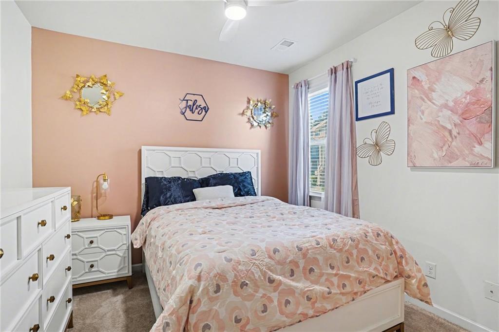 110 Canal Street Hampton, GA 30228 - Photo 21 of 41 a bedroom with a bed and painting on the wall