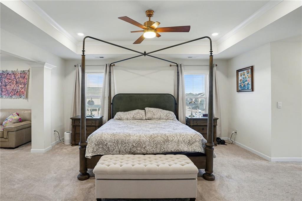 110 Canal Street Hampton, GA 30228 - Photo 26 of 41 a bedroom with a bed and a chandelier