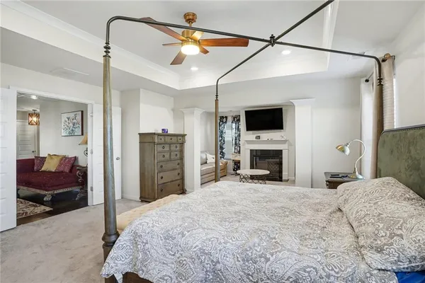 a view of a bedroom with furniture and a flat screen tv