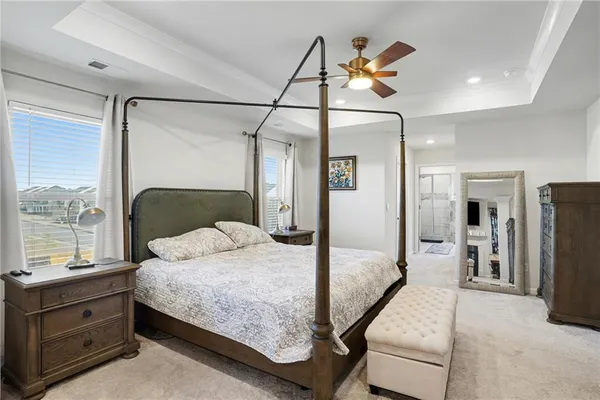 a bedroom with a bed and a painting on the wall