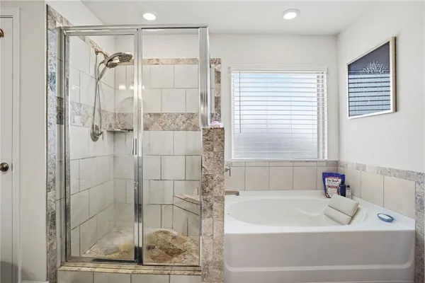 a bathroom with a shower and a bath tub