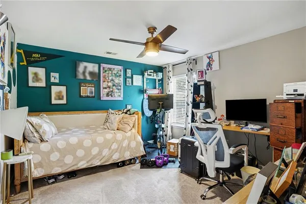 a bedroom with a bed and a desk
