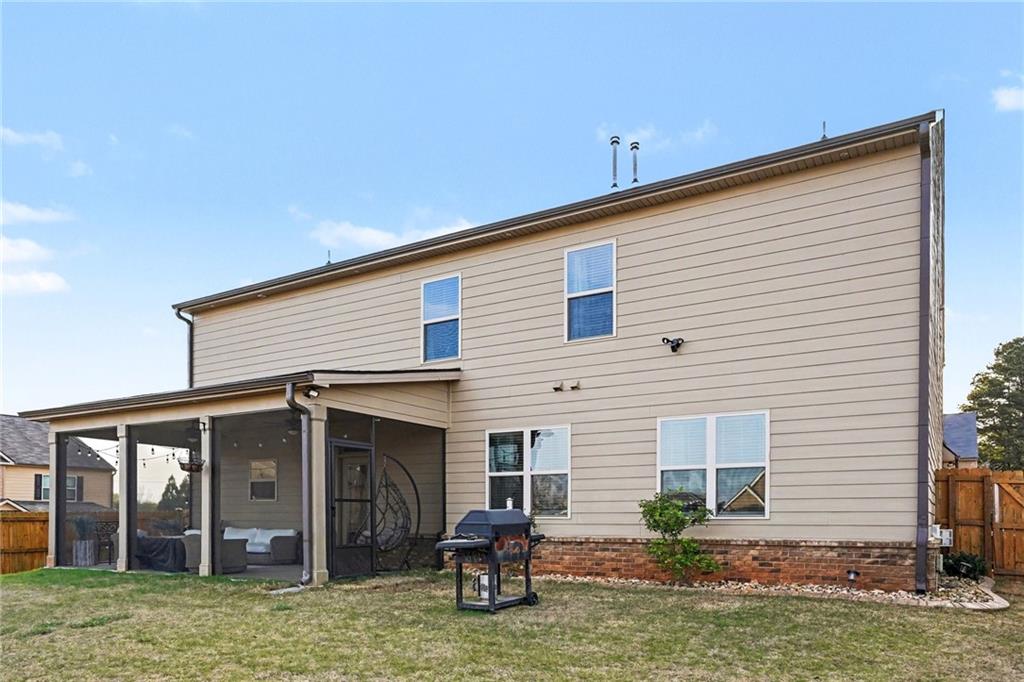 110 Canal Street Hampton, GA 30228 - Photo 41 of 41 a backyard of a house with yard table and chairs