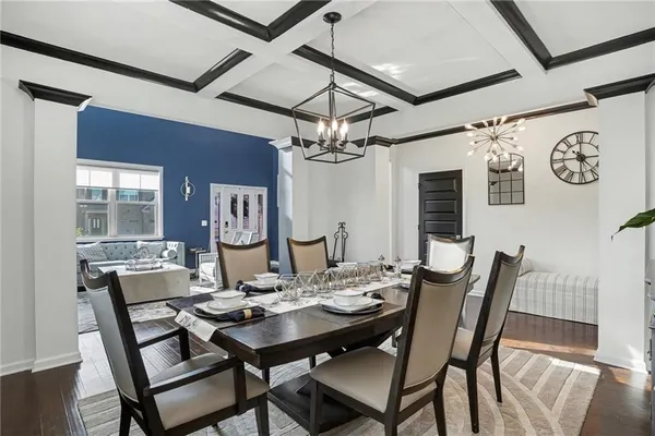a view of a dining room with furniture wooden floor and chandelier