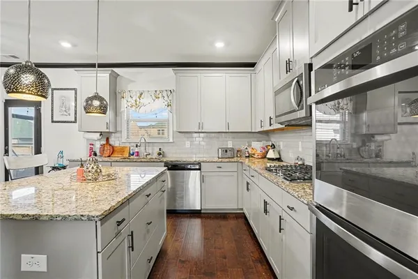 a kitchen with a sink stove and cabinets