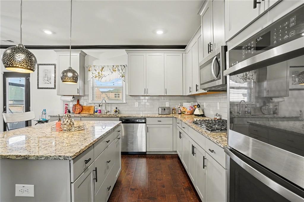 110 Canal Street Hampton, GA 30228 - Photo 9 of 41 a kitchen with a sink stove and cabinets