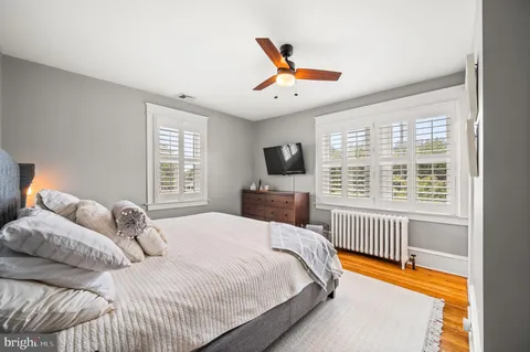 a bedroom with a large bed and a large window