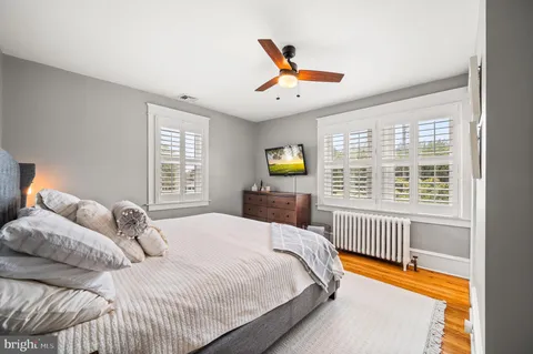 a bedroom with a bed next to a window