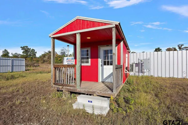 a view of a backyard with a small cabin