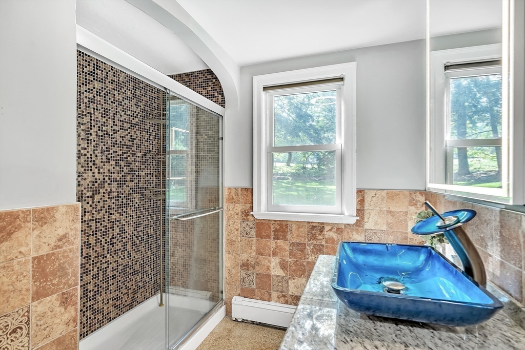 38 Maple Street Lexington, MA 02420 - Photo 11 of 40 a bathroom with a tub sink and a mirror