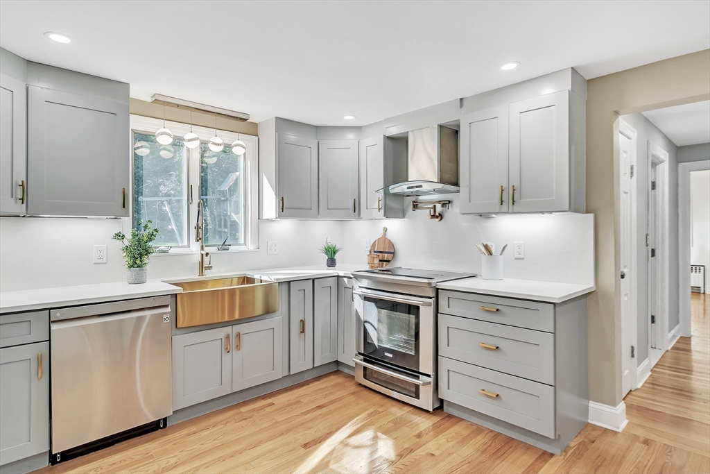 38 Maple Street Lexington, MA 02420 - Photo 18 of 40 a kitchen with stainless steel appliances white cabinets and a stove top oven