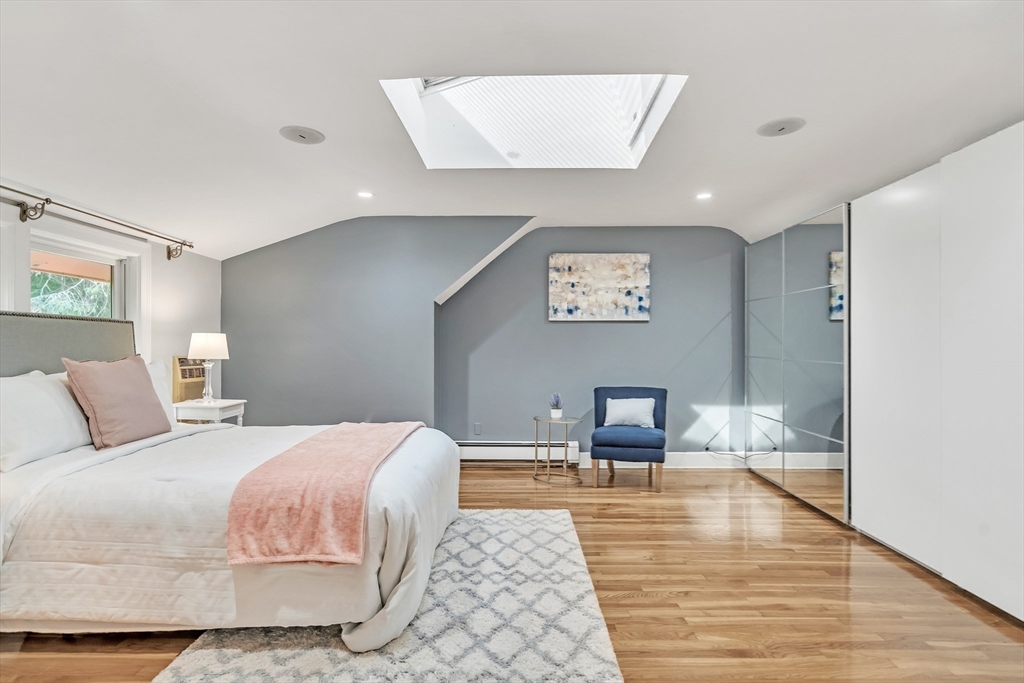 38 Maple Street Lexington, MA 02420 - Photo 21 of 40 a bedroom with a bed and wooden floor