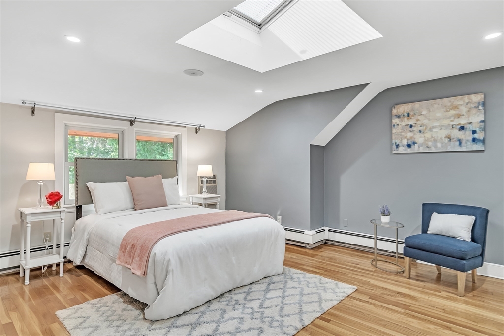 38 Maple Street Lexington, MA 02420 - Photo 23 of 40 a bedroom with a bed and a chair