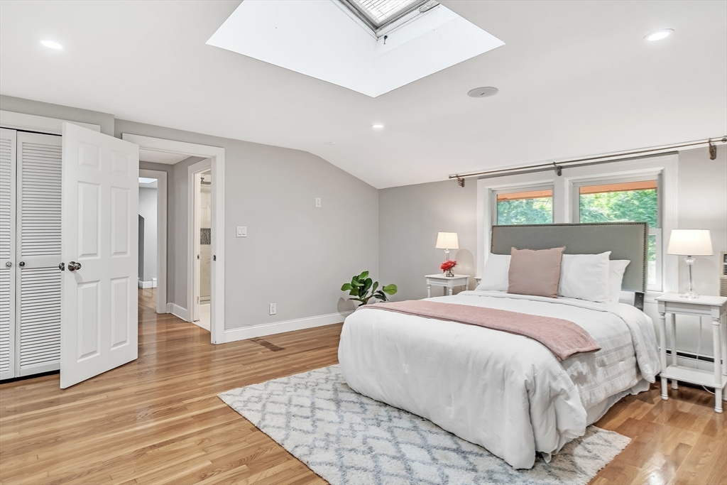 38 Maple Street Lexington, MA 02420 - Photo 25 of 40 a bedroom with a bed and wooden floor